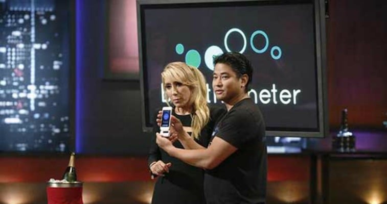 Charles Yim holding up a prototype of breathometer on Shark Tank.