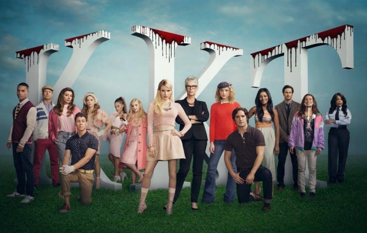 The cast of Scream Queens pose in front of sorority letters
