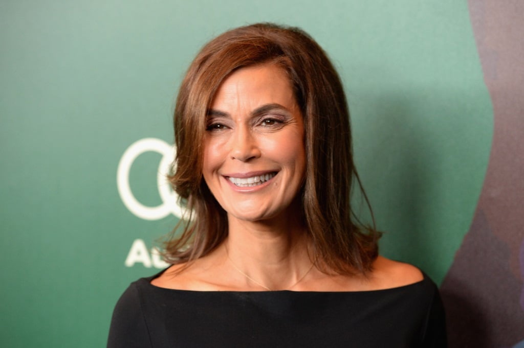 Teri Hatcher smiling in a black shirt while on the red carpet