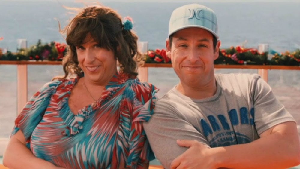 Adam Sandler as Jack and Jill is sitting next to each other smiling