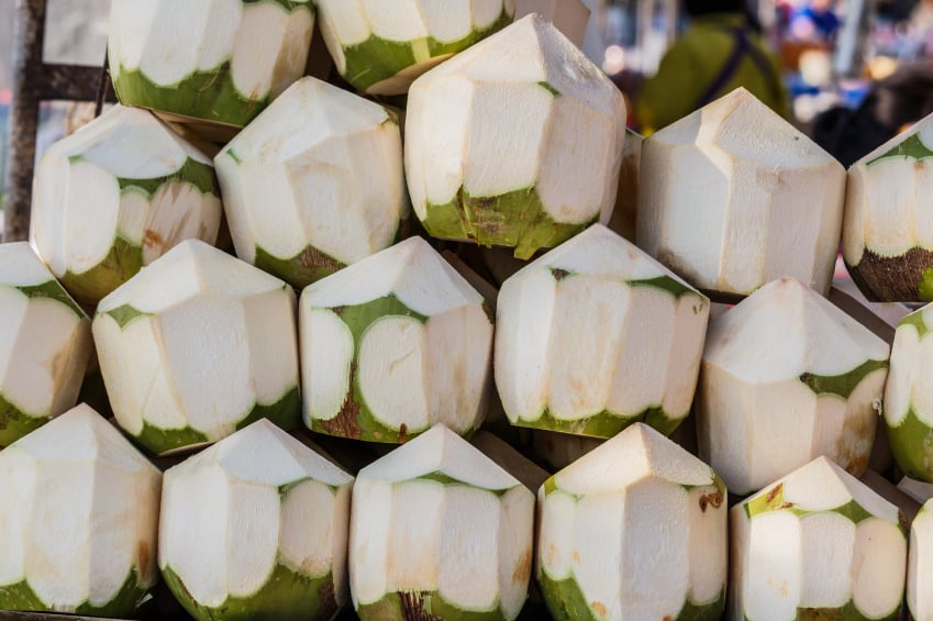 stack of freshly cut young Thai coconuts