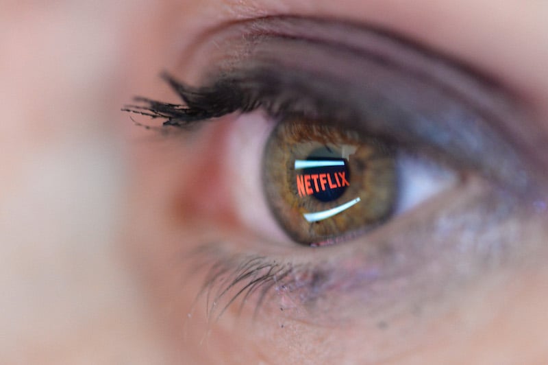 The Netflix logo reflected in the eye of a user