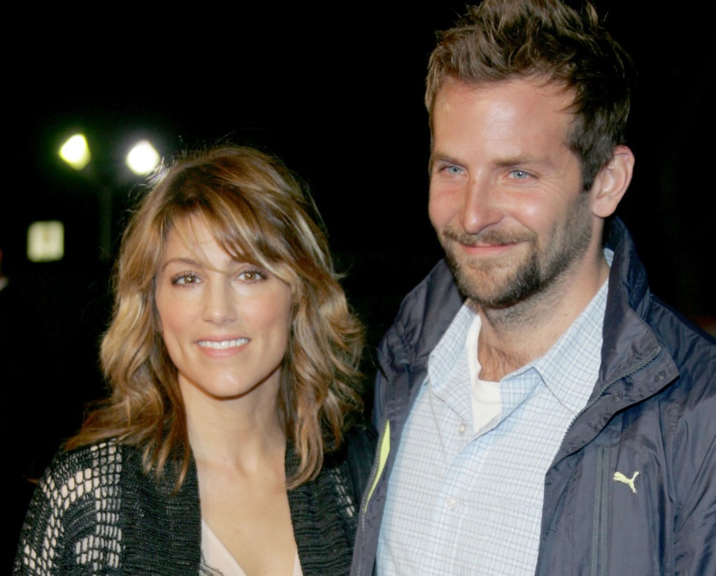 Bradley Cooper with his arm around Jennifer Esposito, while they both smile for the camera
