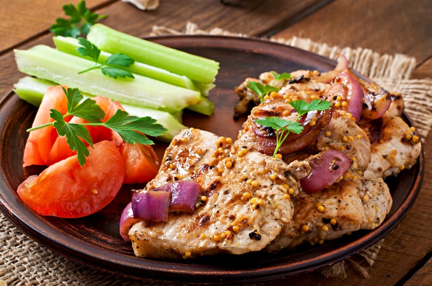 pork chops with mustard and red onion sauce with a side of raw vegetables