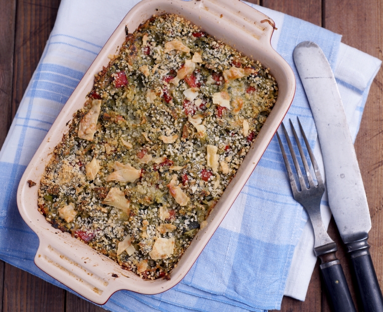 Spinach casserole in a dish with fork and knife