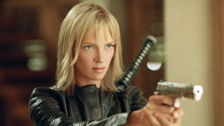 Uma Thurman in Kill Bill: Vol. 2 holds a gun while wearing a black leather jacket