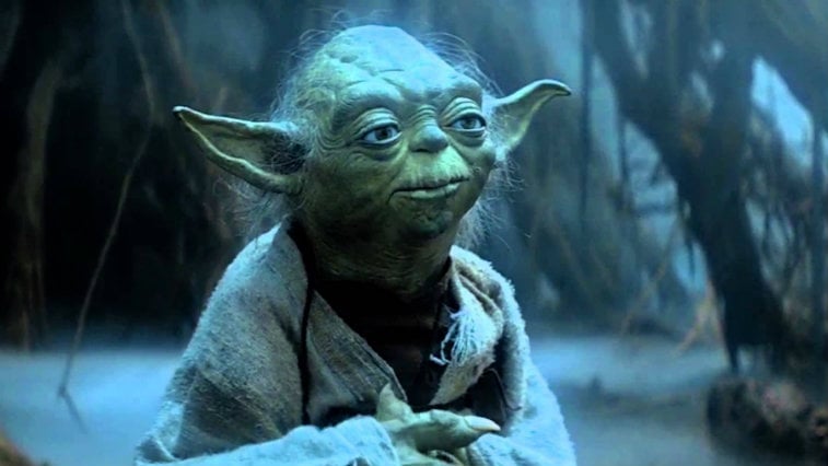 Yoda looking up, with his hands folded
