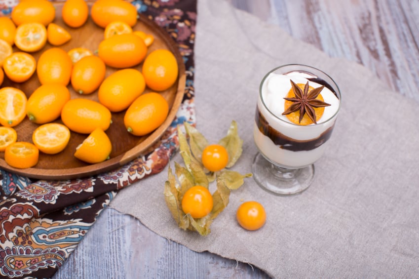custard parfait with kumquats and spices in a glass