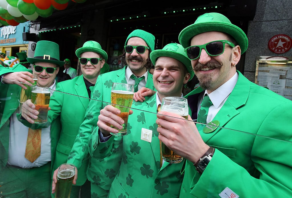 Group of men toast beers for St. Patrick's Day in Dublin, Ireland
