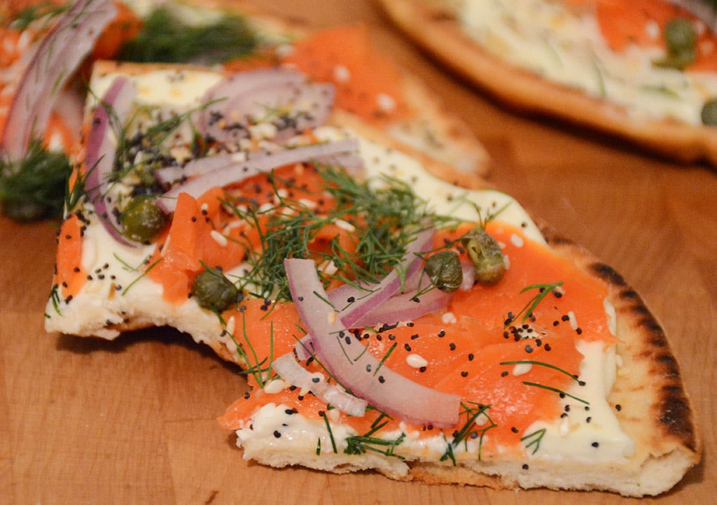 Slice of bitten Smoked Salmon Bagel Flatbread