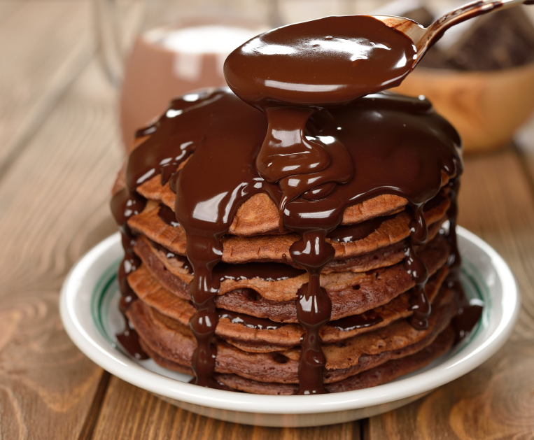 Chocolate pancakes on a wooden table
