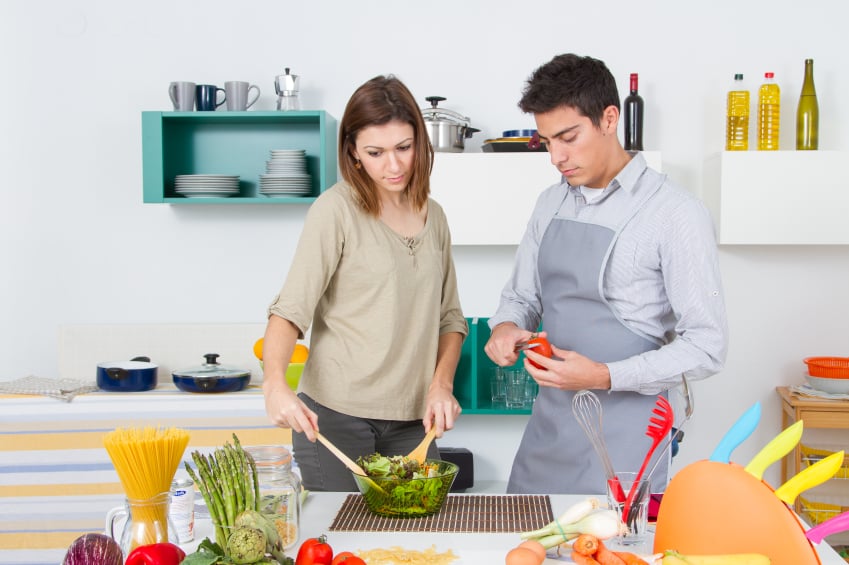 Couple making salad together in the Kitchen