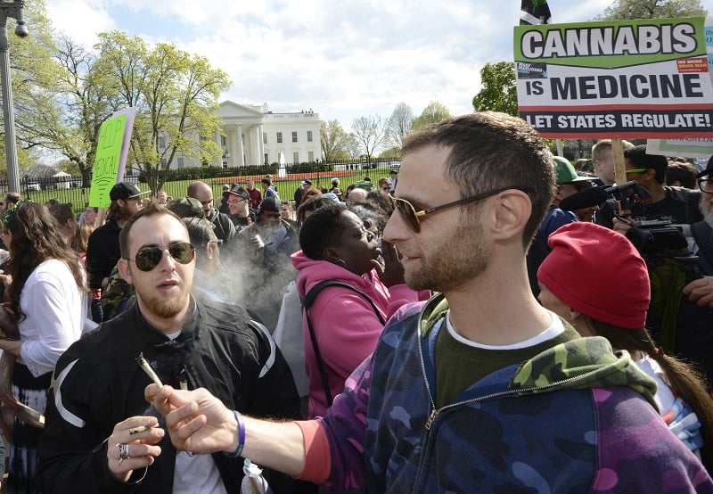 Advocates for the legalization of marijuana light up in front of the White House during a demonstration