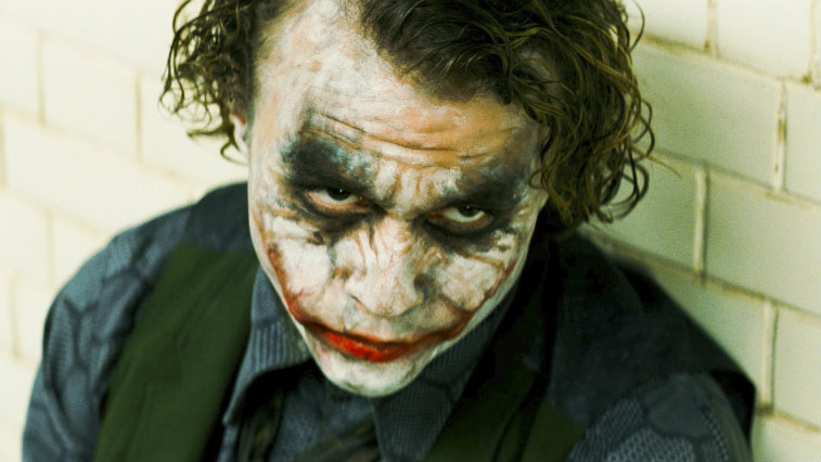 The Joker with some of his makeup off is looking up in The Dark Knight.