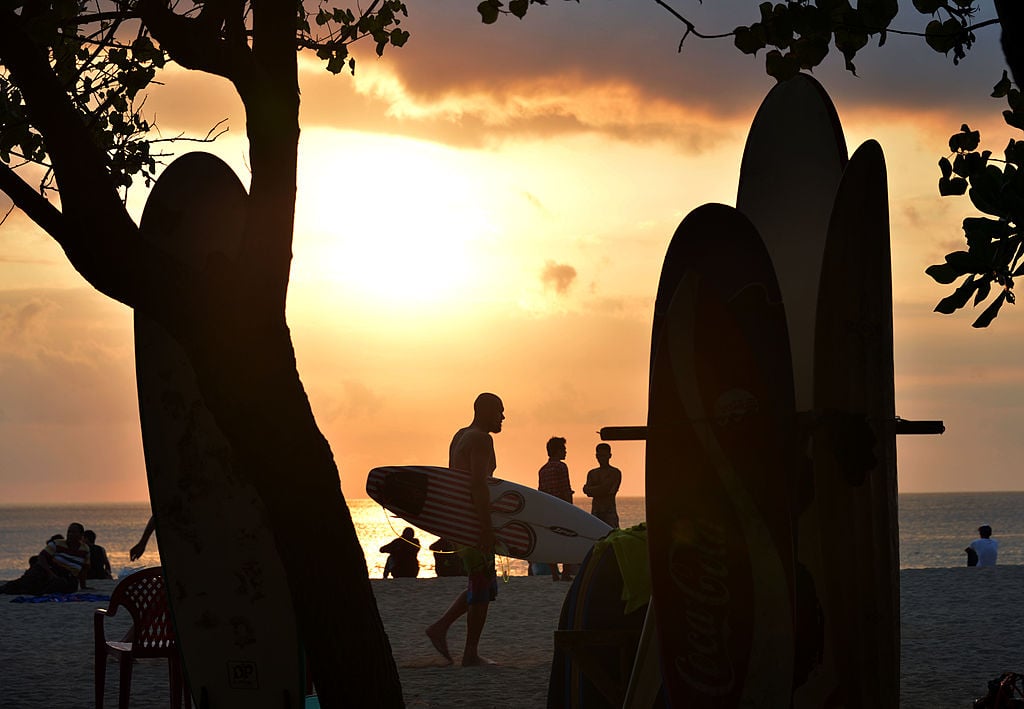 surfers on the beach in Bali