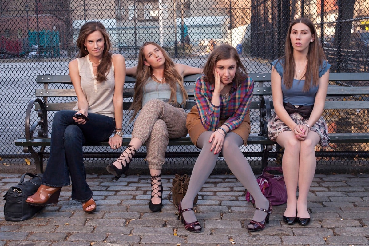 Marnie, Jessa, Hannah, and Shoshanna sit on a bench in NYC