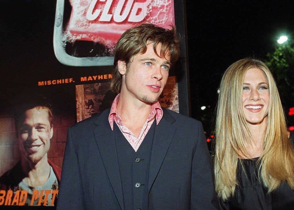 Brad Pitt with Jennifer Aniston in front of a Fight Club poster