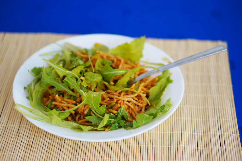 spaghetti with arugula in a bowl