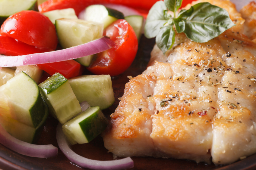grilled fish with zucchini, onions, tomatoes, and herbs