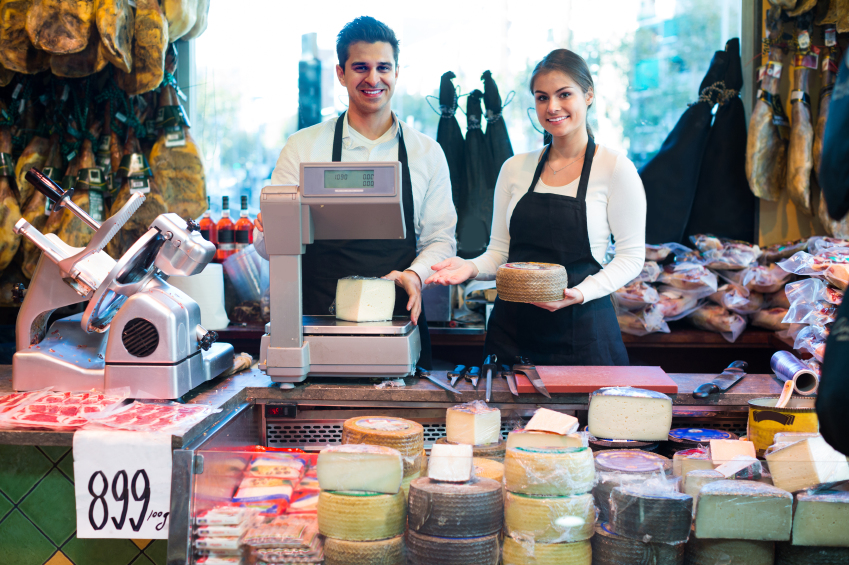 man and woman cheesemonger happy to make a sale