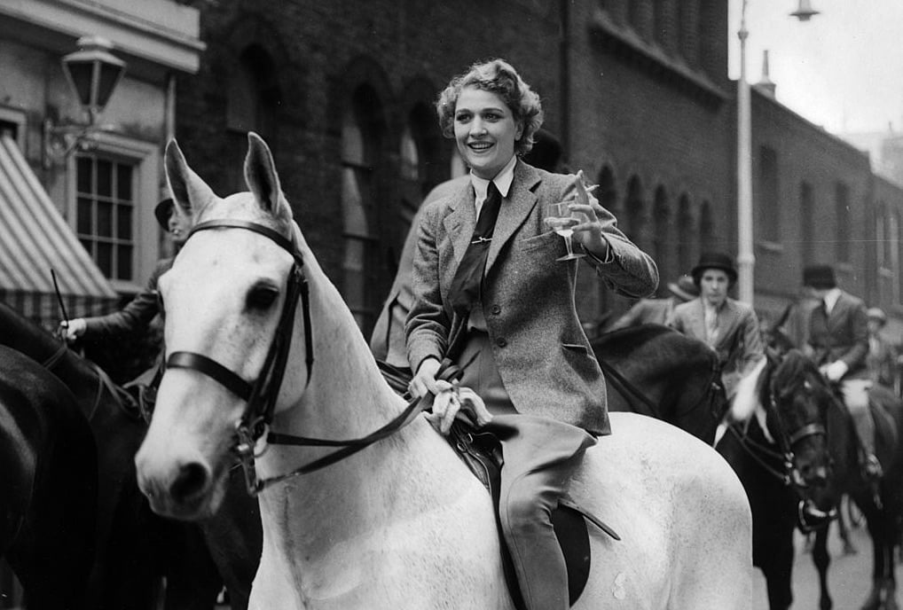 woman on horse drinking champagne