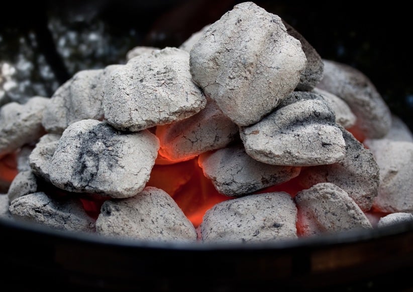 close-up of a pile of burning charcoal in a grill