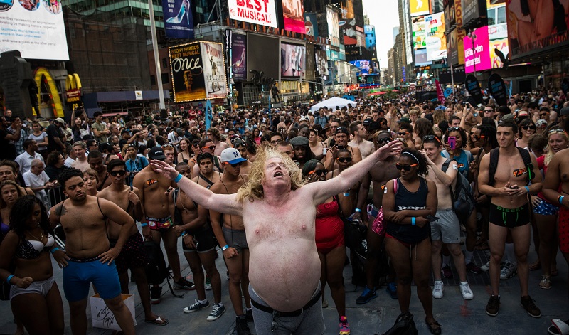 A large man in large undies dances in times square