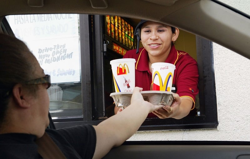 customer at a McDonald's drive-thru receiving his order