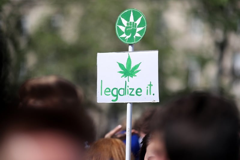 A banner picturing a cannabis leaf and reading "legalize it" during a march for cannabis and marijuana in Paris | Kenzo Tribouillard/AFP/Getty Images