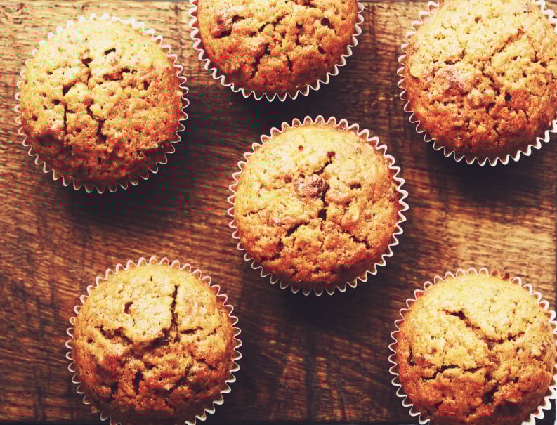 overhead shot of carrot muffins on a wooden counter