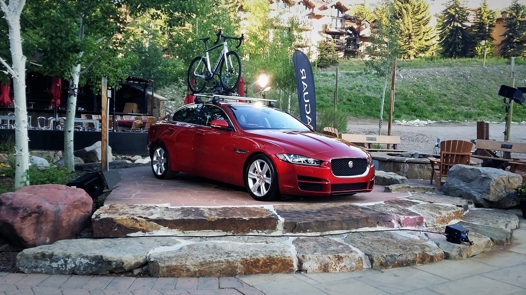 A red Jaguar XE Sport Sedan on display.