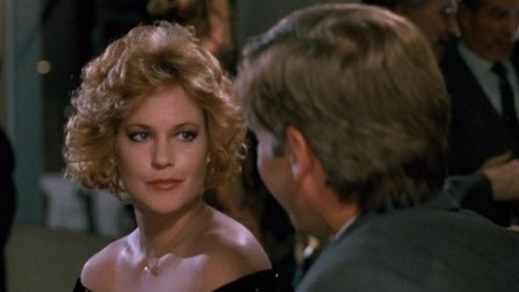 Melanie Griffith looks at a man in Working Girl