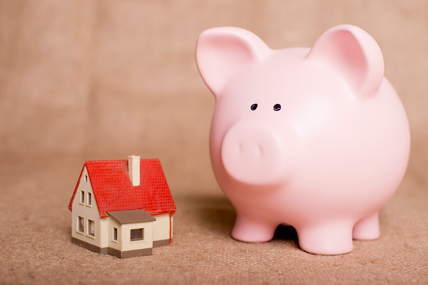 piggy bank beside a small house