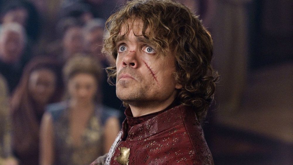 Peter Dinklage as Tyrion Lannister in Game of Thrones with a scar on his cheek, looking shocked