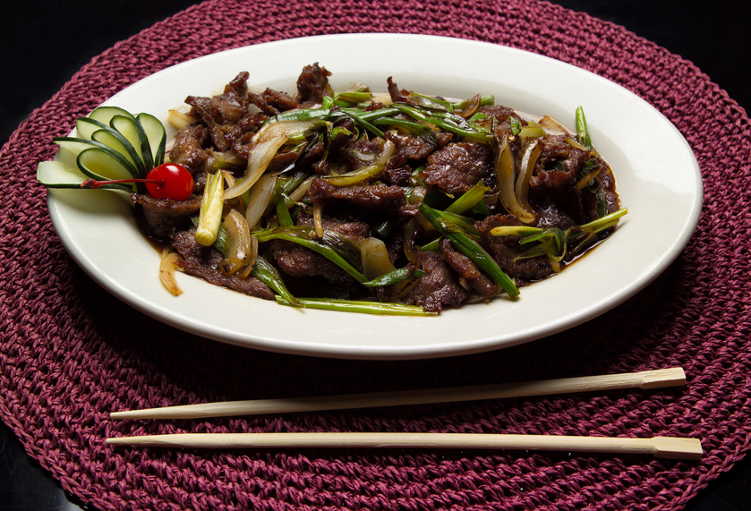 Mongolian beef on a rimmed white plate