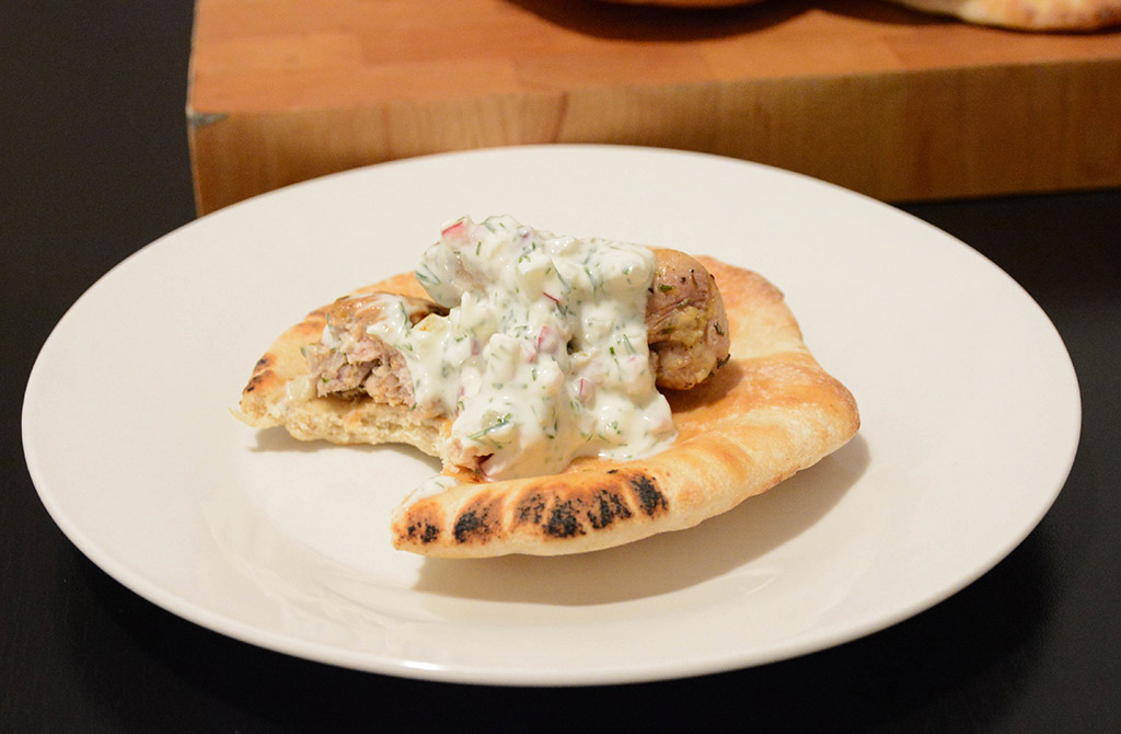 close-up of an individual portion of mini pita with chicken souvlaki