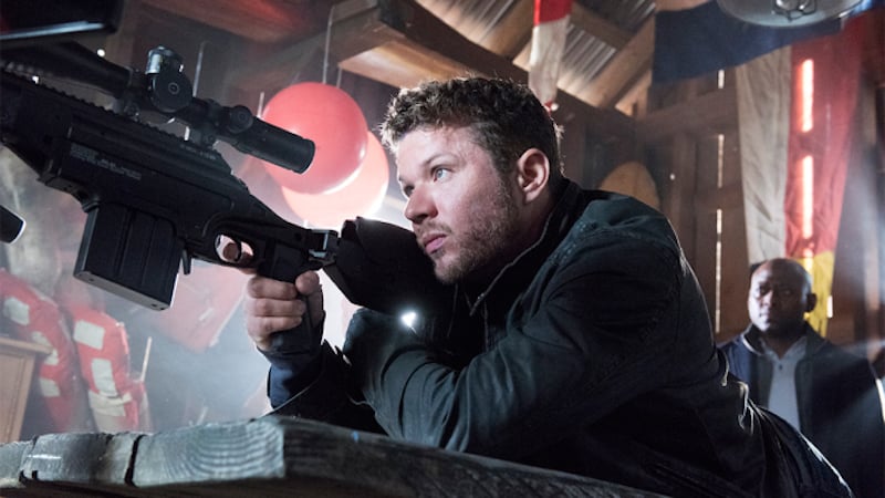 Ryan Phillippe holds up a gun in a scene from Shooter