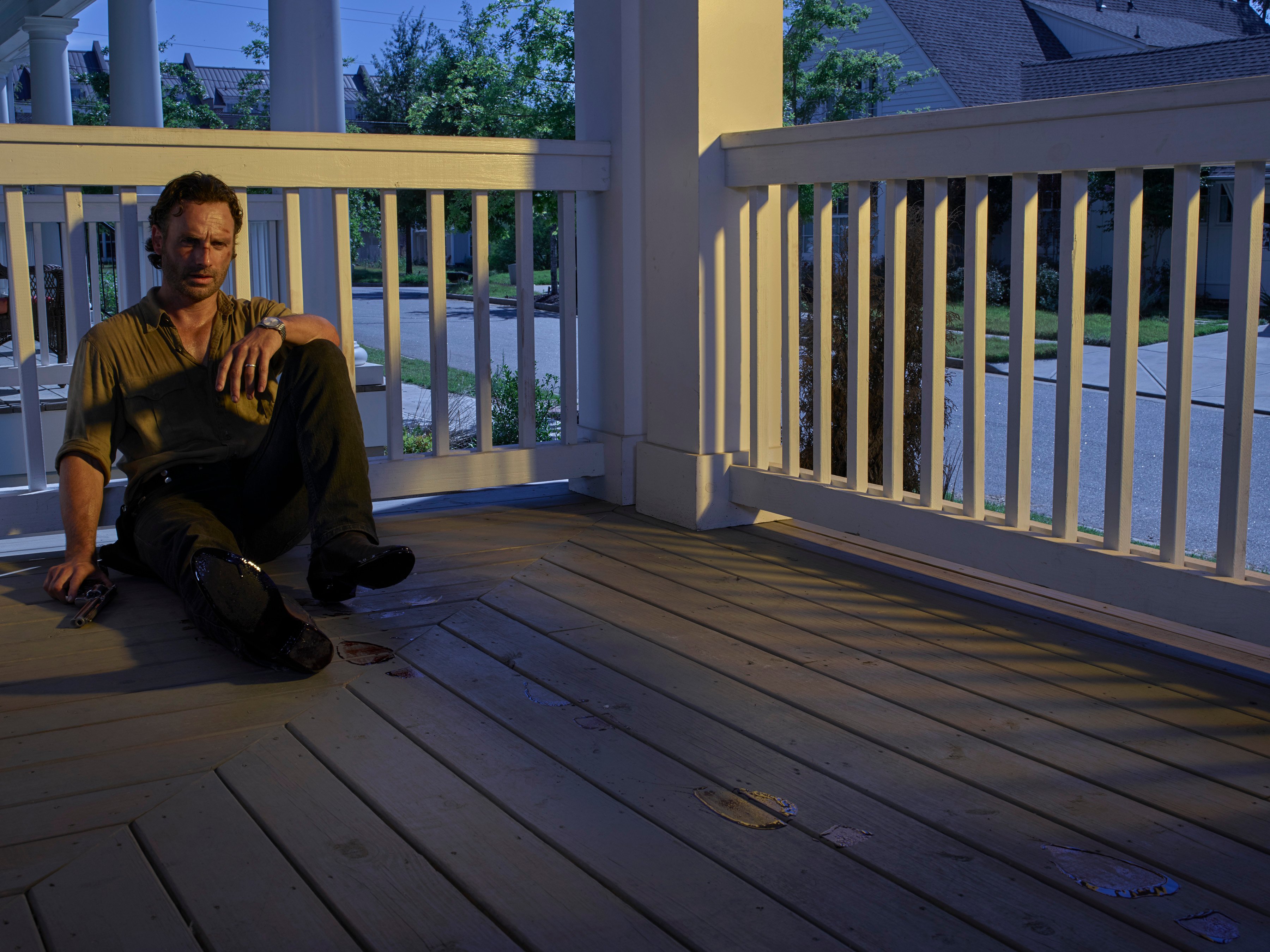 Rick Grimes (Andrew Lincoln) sits alone on a porch in a scene from the sixth season of 'The Walking Dead'