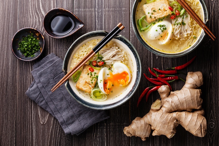 overhead image of two bowls of ramen noodle soup with eggs