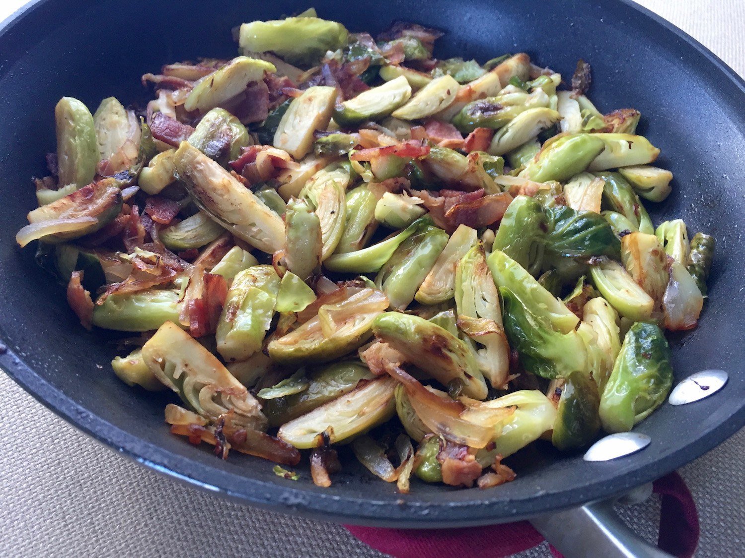 Brussels sprouts in a pan with onion and bacon