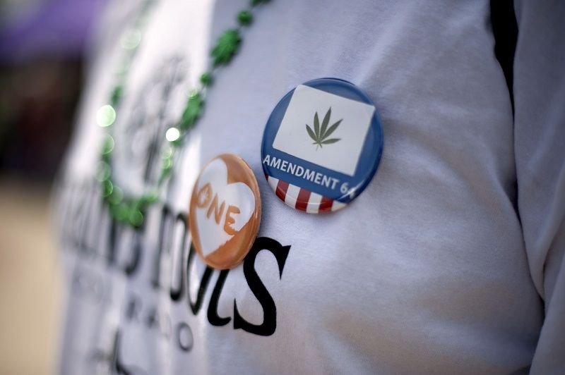 Pro-marijuana buttons are seen during the Denver 420 Rally