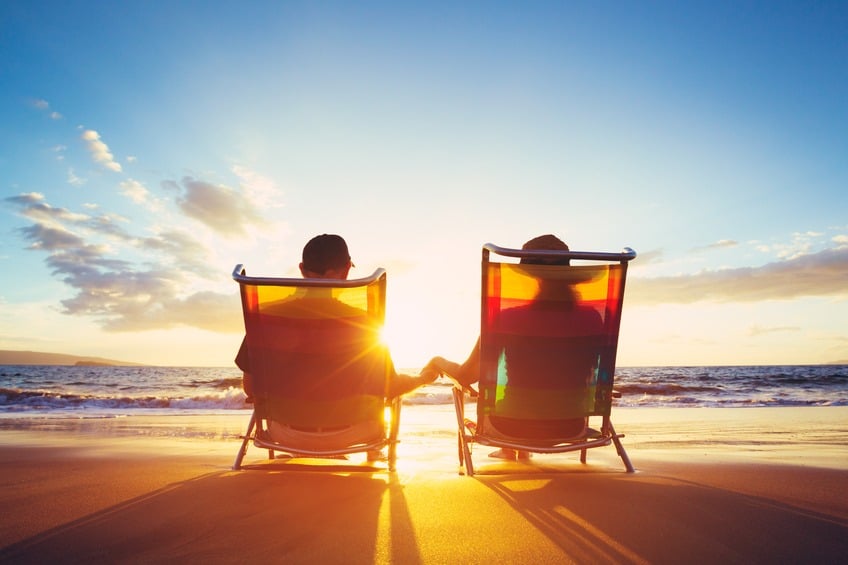 man and woman enjoying retirement at a beach