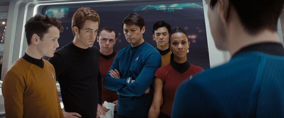 The cast of Star Trek stands together on the bridge of the Enterprise