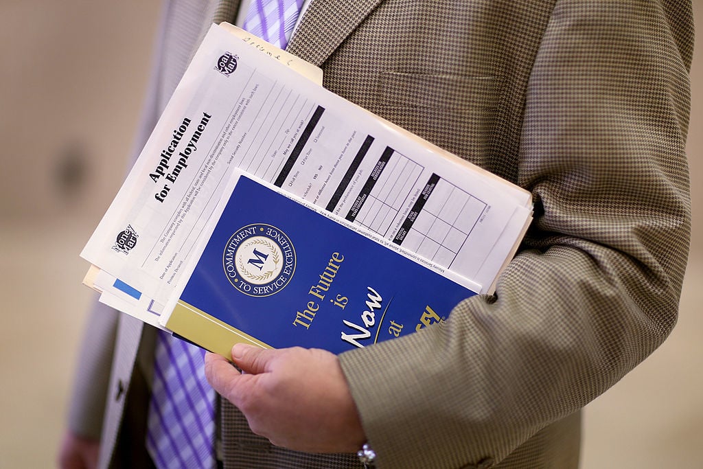 an unemployed man hold a job application