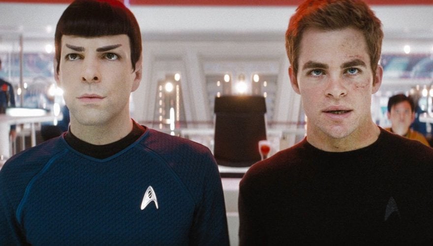 Spock and Kirk look upwards, standing shoulder to shoulder on the Enterprise