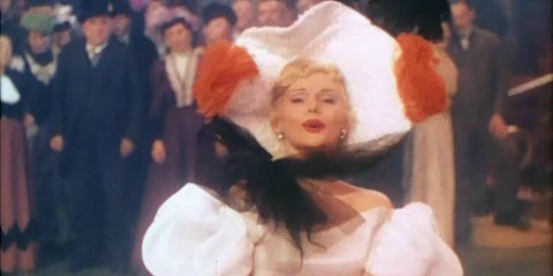 Zsa Zsa in a white dress and hat on Moulin Rouge 