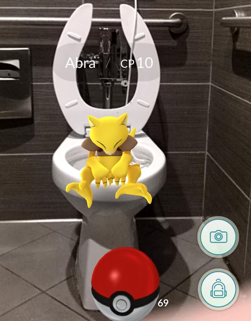 A Pokemon sits on a toilet.