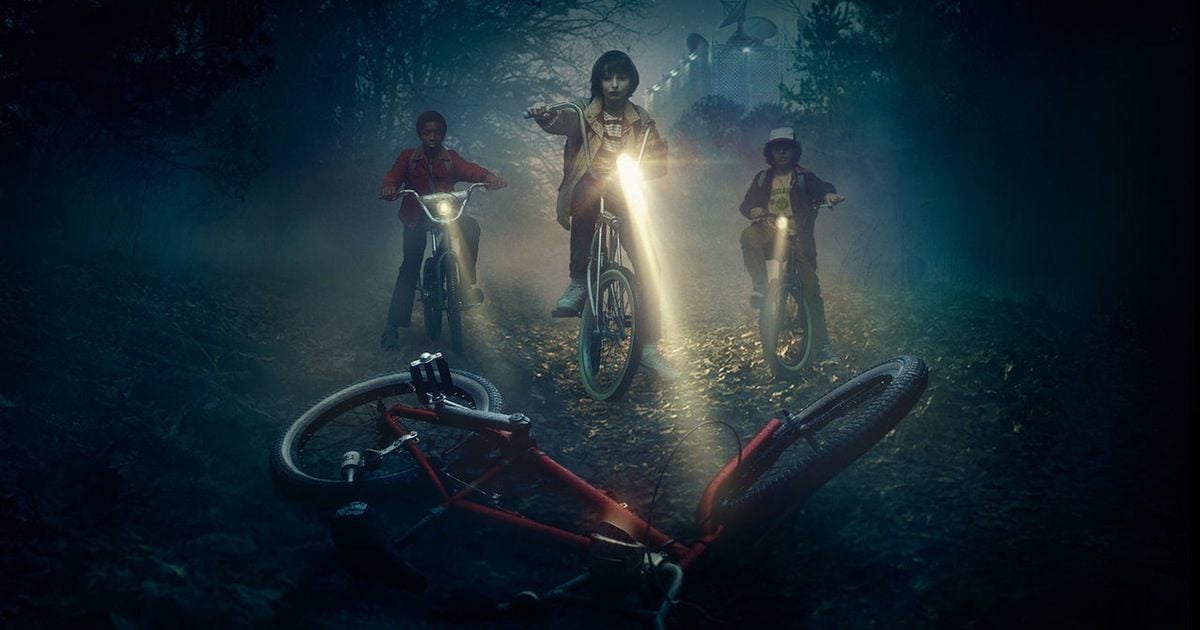 Promotional art from Netflix's 'Stranger Things' shows Lucas, Mike and Dustin on their bikes in front of Will's abandoned bike.