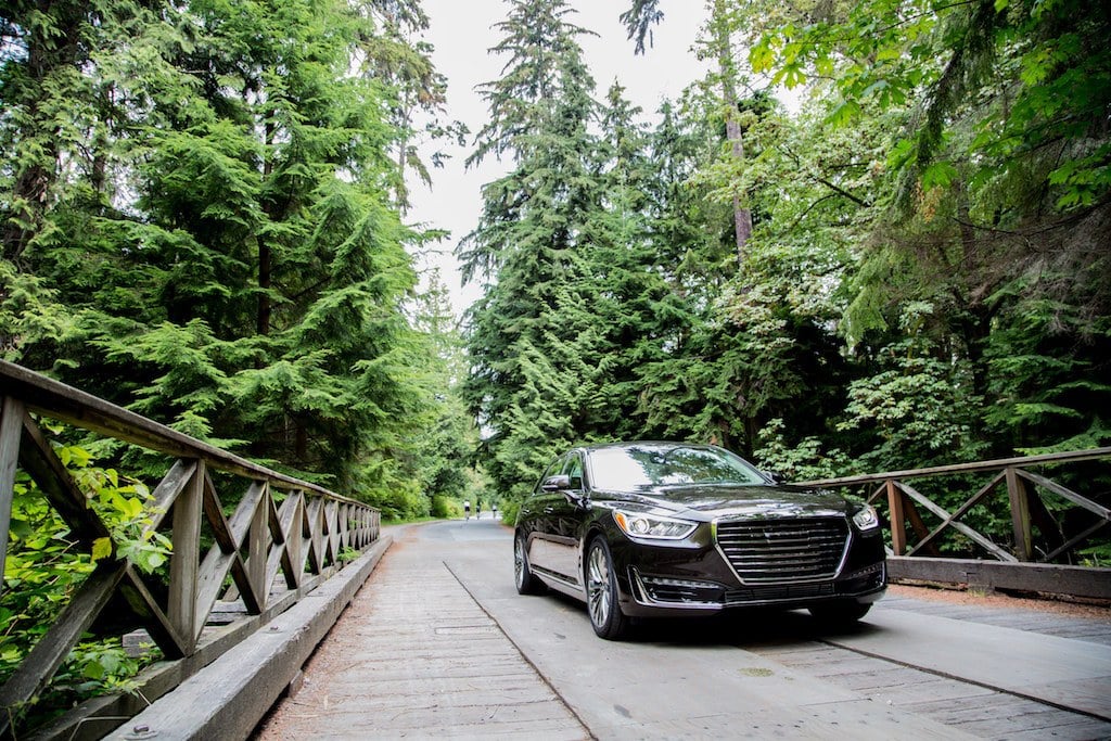 Black 2017 Genesis G90 on a wooden bridge.