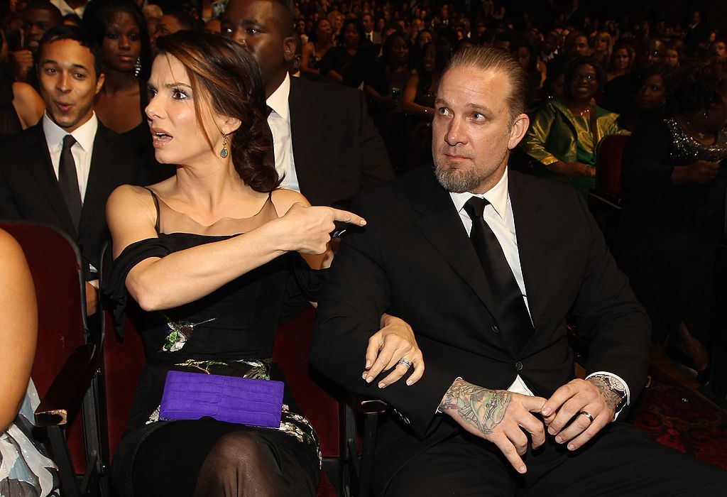 Actress Sandra Bullock points to husband Jesse James